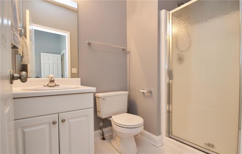 24 Intown Place Fayetteville, GA 30214 - Photo 13 of 18 a bathroom with a sink a toilet and shower