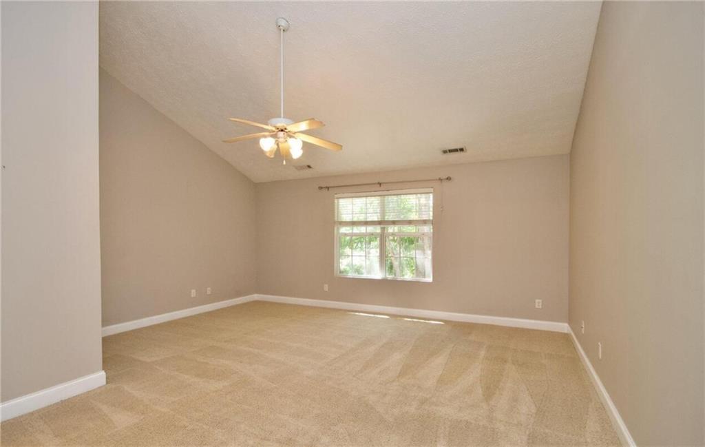 24 Intown Place Fayetteville, GA 30214 - Photo 15 of 18 an empty room with chandelier fan and windows