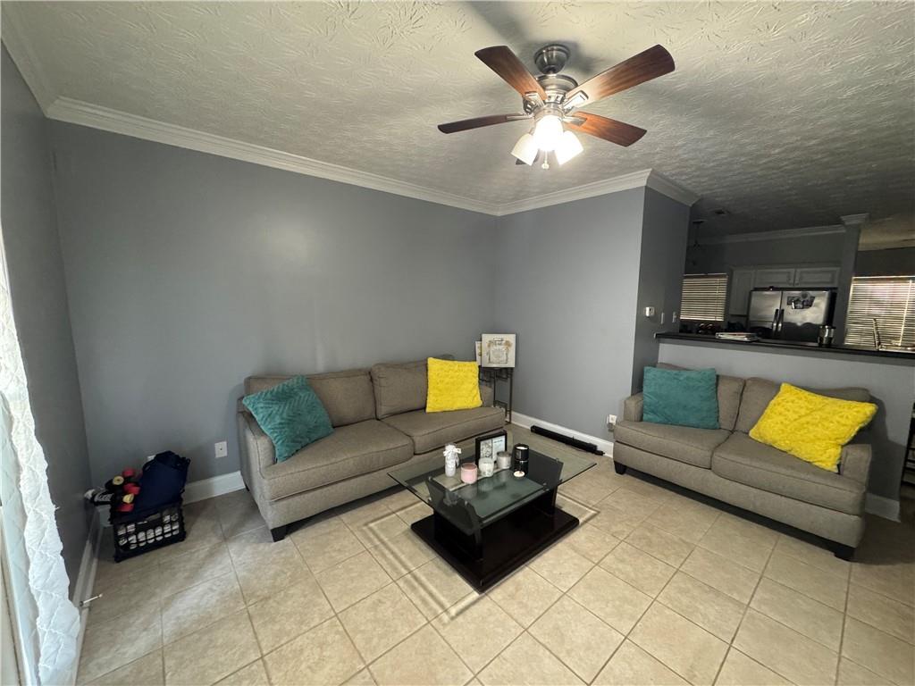 24 Intown Place Fayetteville, GA 30214 - Photo 2 of 18 a living room with furniture and a chandelier