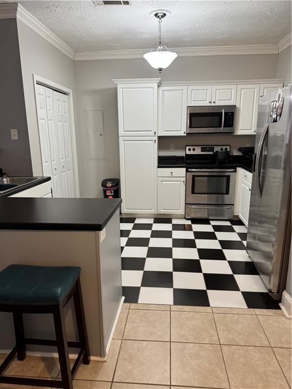 24 Intown Place Fayetteville, GA 30214 - Photo 5 of 18 a kitchen with granite countertop stainless steel appliances a stove a microwave and a refrigerator