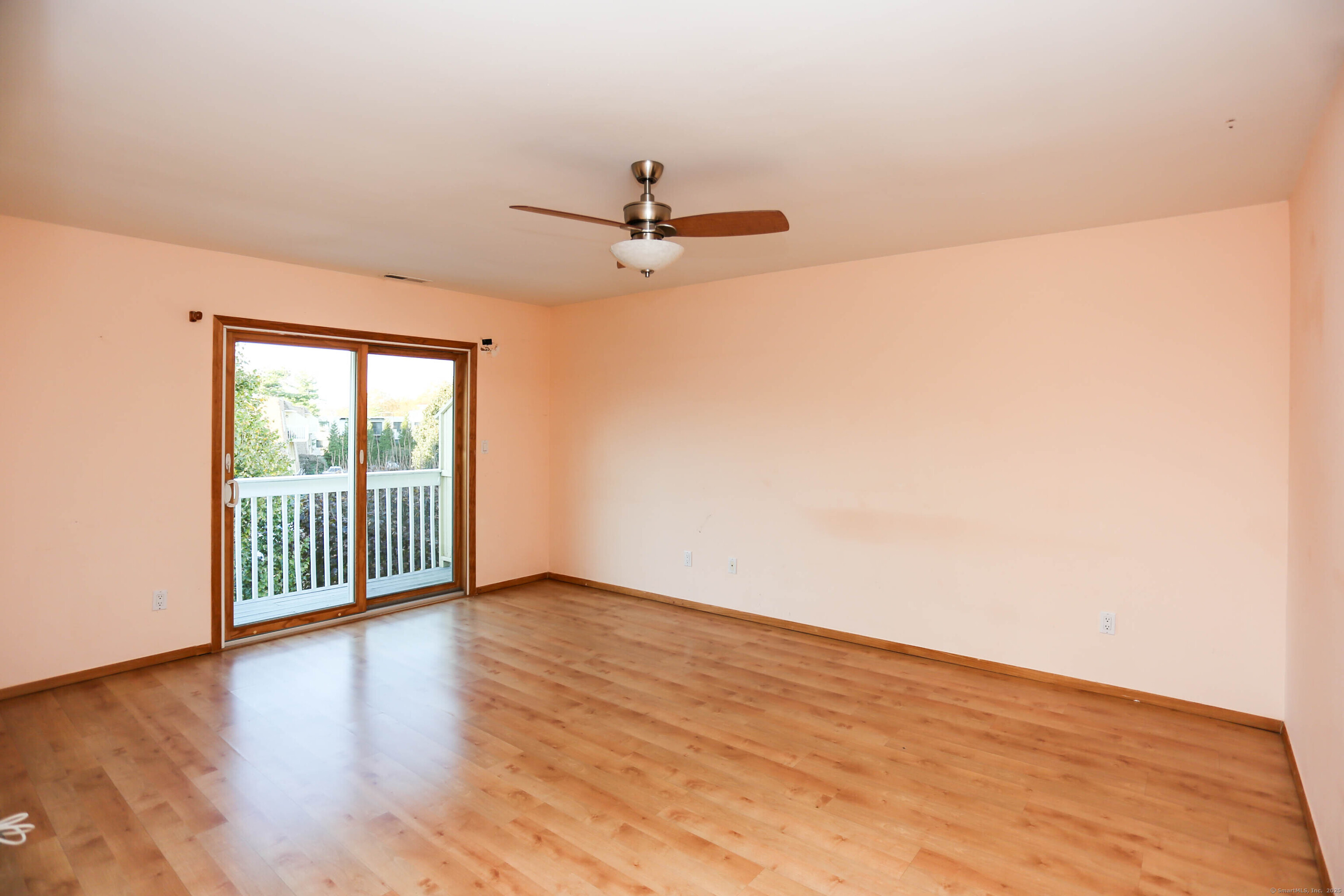 61 Seaview Avenue, Unit 51 Stamford, CT 06902 - Photo 11 of 27 an empty room with wooden floor fan and windows