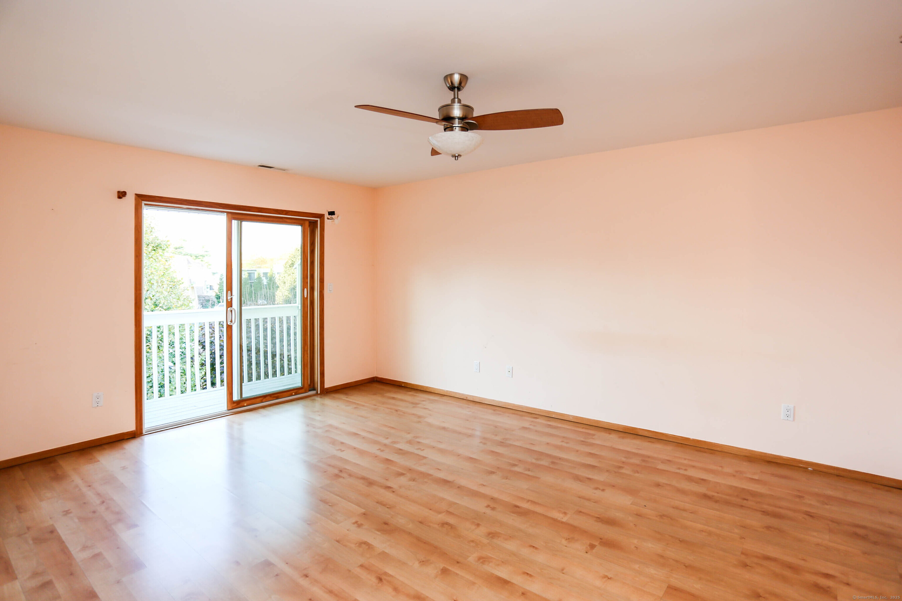 61 Seaview Avenue, Unit 51 Stamford, CT 06902 - Photo 13 of 27 a view of a room with wooden floor and a ceiling fan