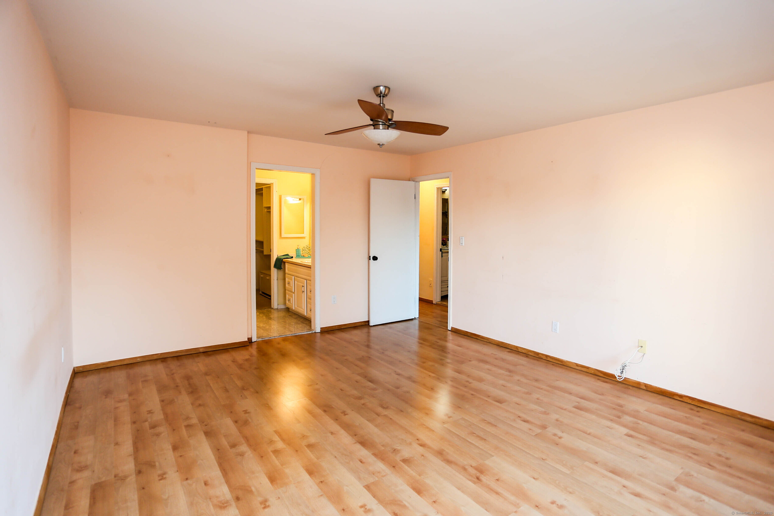 61 Seaview Avenue, Unit 51 Stamford, CT 06902 - Photo 14 of 27 an empty room with wooden floor ceiling fan and windows