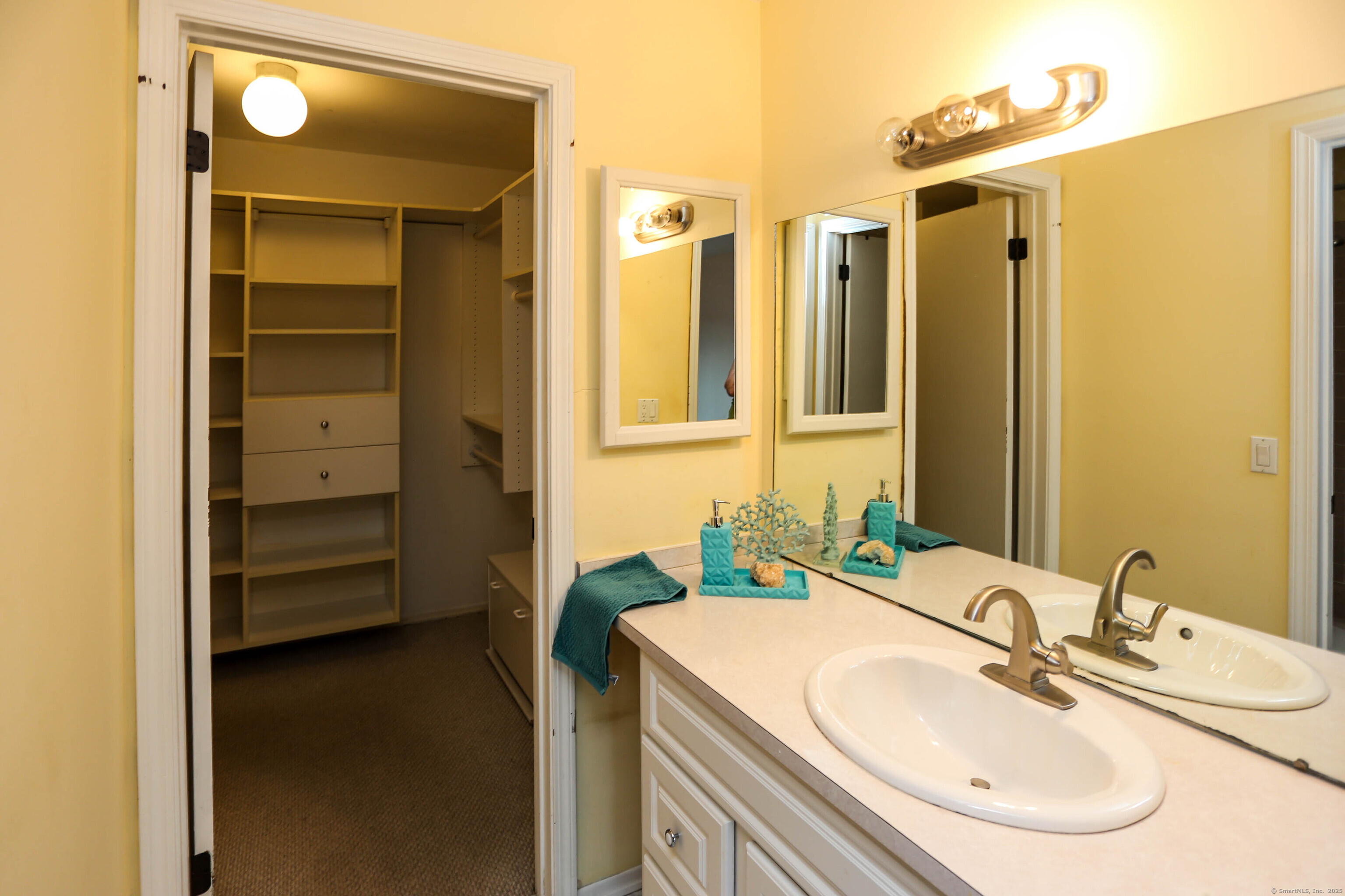 61 Seaview Avenue, Unit 51 Stamford, CT 06902 - Photo 18 of 27 a bathroom with a sink double vanity and a mirror