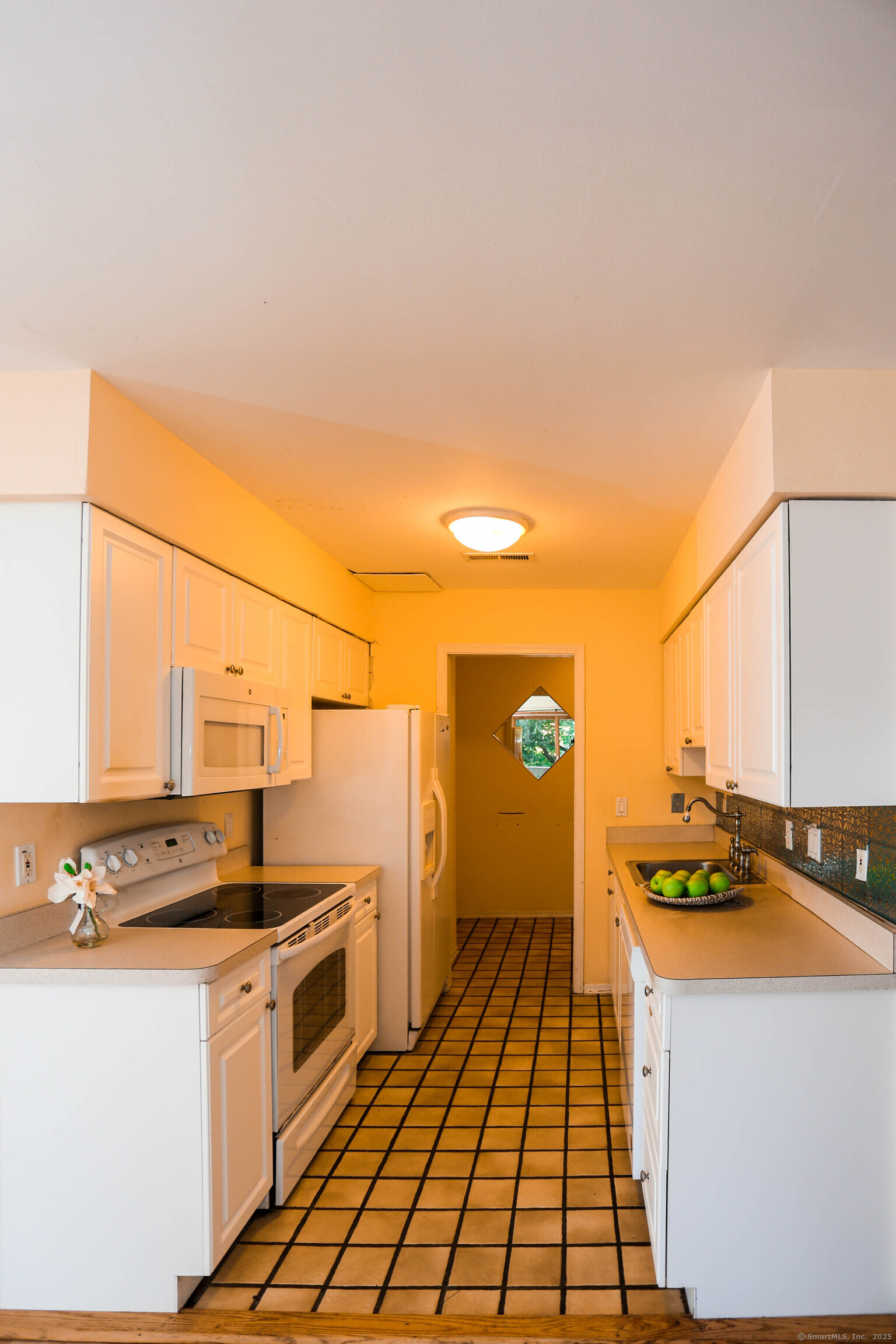 61 Seaview Avenue, Unit 51 Stamford, CT 06902 - Photo 3 of 27 a kitchen with a sink stove and cabinets