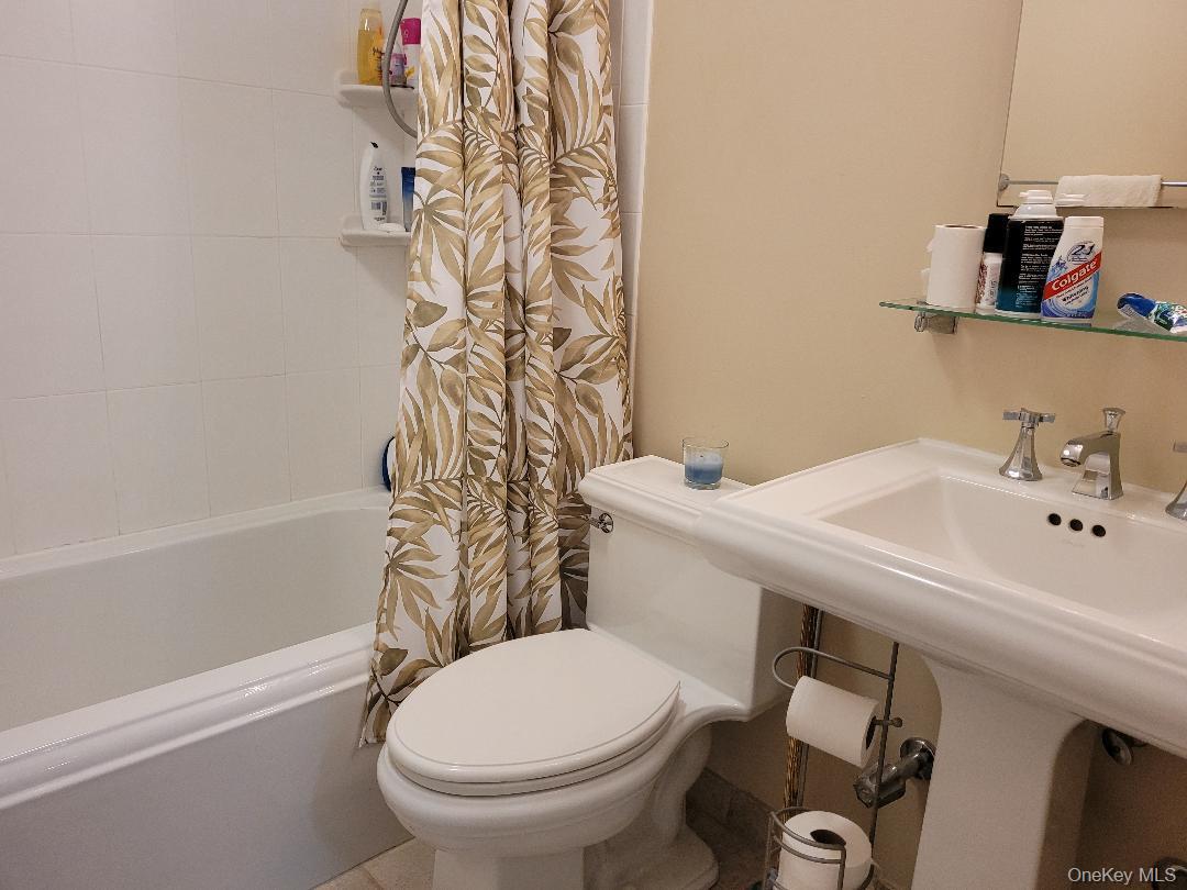 79 Rochester Avenue, Unit GARDEN Long Beach, NY 11561 - Photo 11 of 15 a bathroom with a sink a toilet and shower