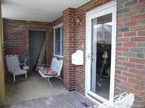 a view of a door with a bench and chair