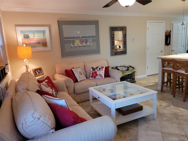 a living room with furniture and a dining table