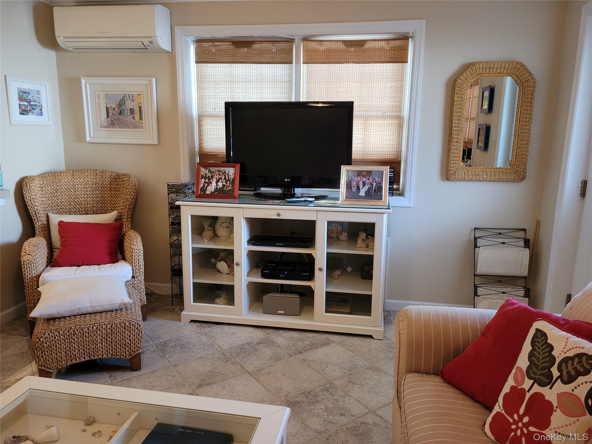 79 Rochester Avenue, Unit GARDEN Long Beach, NY 11561 - Photo 4 of 15 a living room with furniture and a flat screen tv