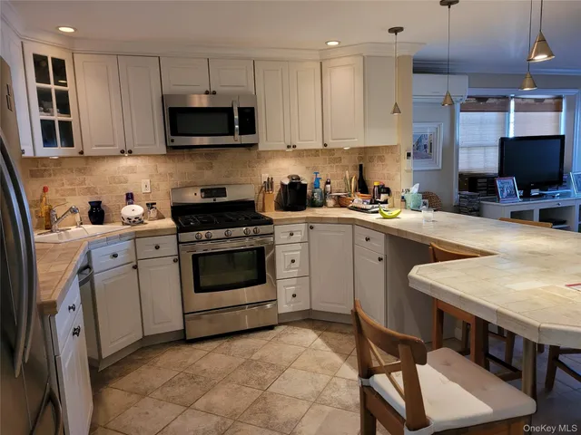 a kitchen with a stove a sink and a microwave