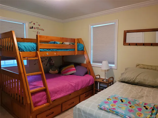 a bedroom with two beds and painted walls