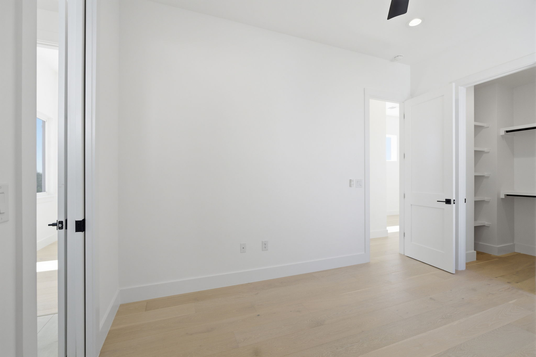 400 Post Rd Drive Austin, TX 78704 - Photo 16 of 23 Unfurnished bedroom featuring light wood finished floors, a walk in closet, recessed lighting, and a ceiling fan