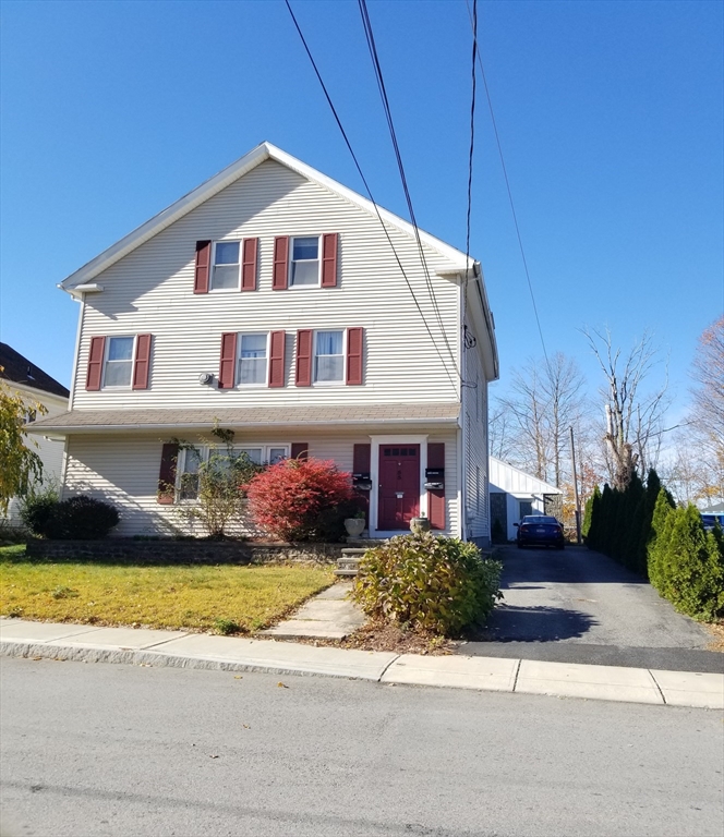 55 Granite Street Webster, MA 01570 - Photo 2 of 5 a front view of a house with a yard and garage
