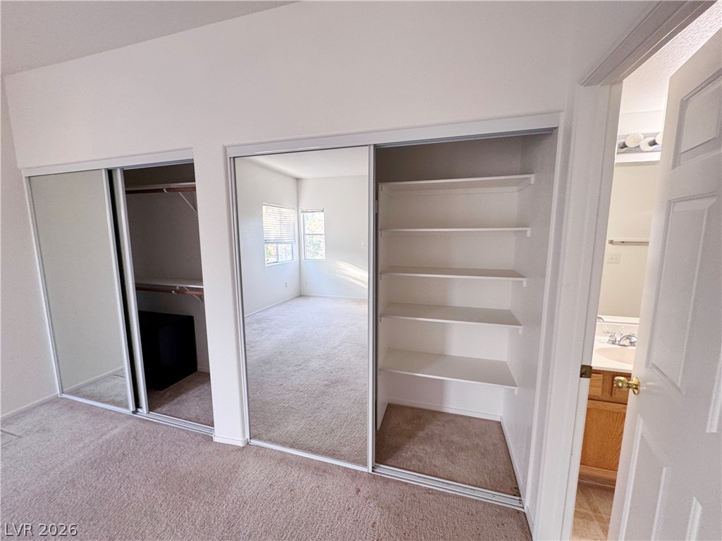 9580 West Reno Avenue, Unit 242 Las Vegas, NV 89148 - Photo 16 of 26 Ample mirrored closets and built-in shelving maximize storage within this naturally lit space.