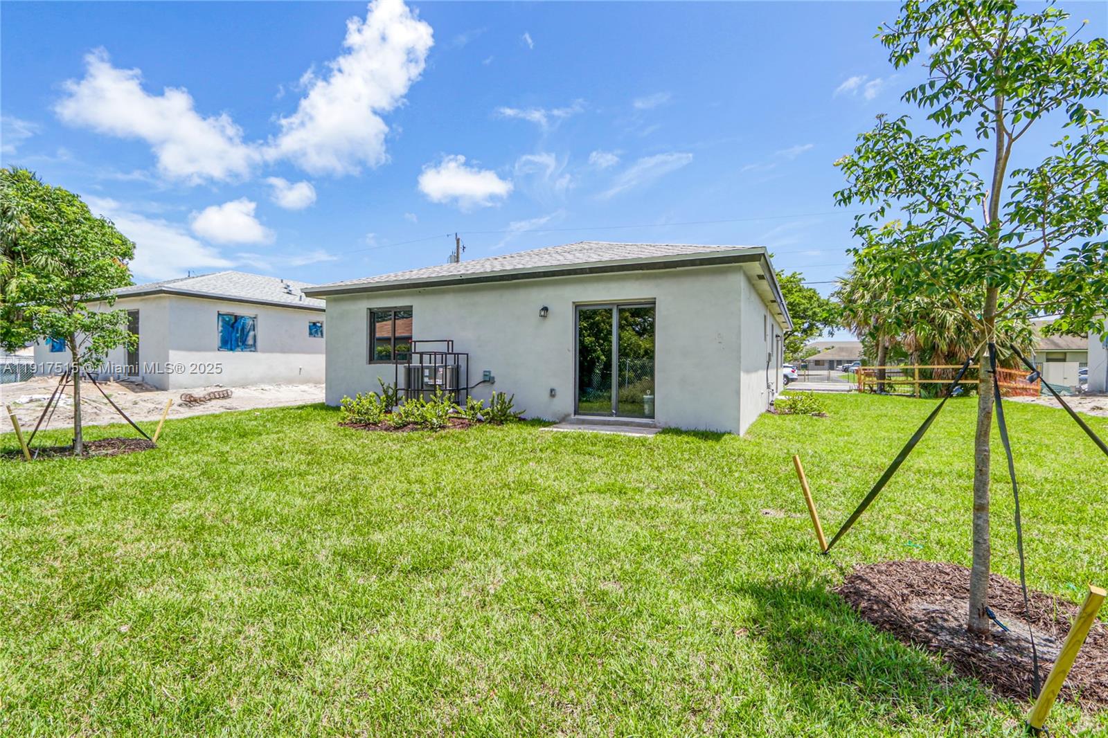 981 Northwest 4th Avenue, Unit 1 Pompano Beach, FL 33060 - Photo 4 of 12 a backyard of a house with table and chairs