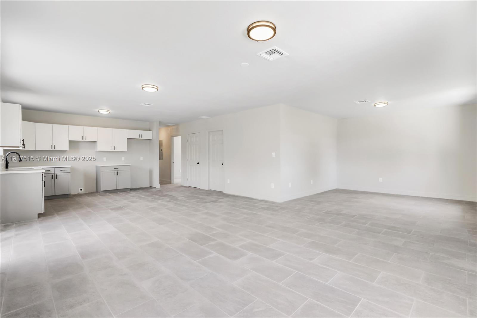 981 Northwest 4th Avenue, Unit 1 Pompano Beach, FL 33060 - Photo 8 of 12 a view of a kitchen with a sink and dishwasher a refrigerator freezer