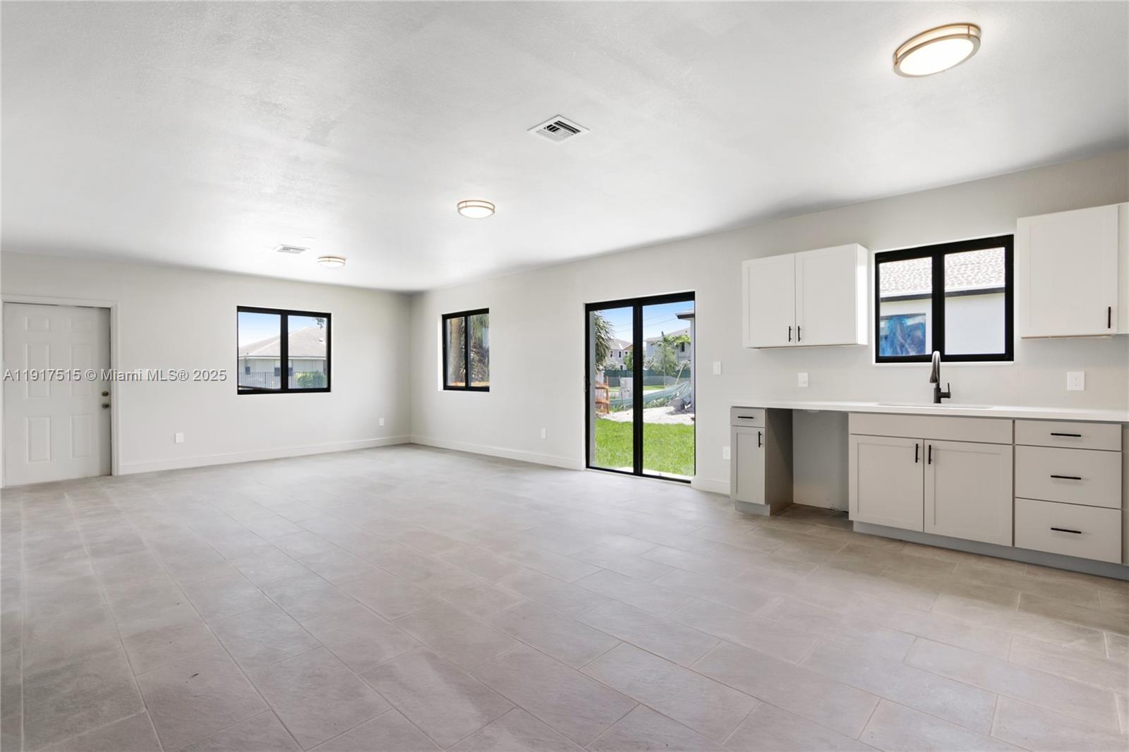 981 Northwest 4th Avenue, Unit 1 Pompano Beach, FL 33060 - Photo 9 of 12 a view of a kitchen and a sink and window in a room