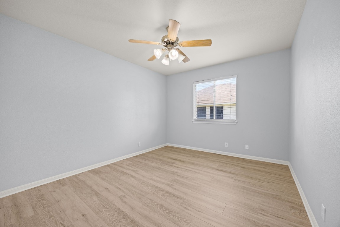 1323 Anna Palm Way Round Rock, TX 78665 - Photo 19 of 29 wooden floor in an empty room with a window