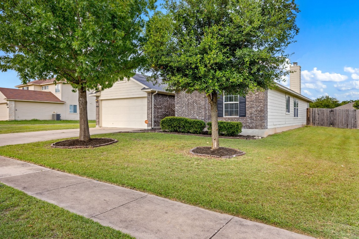 1323 Anna Palm Way Round Rock, TX 78665 - Photo 2 of 29 a front view of house with yard and green space