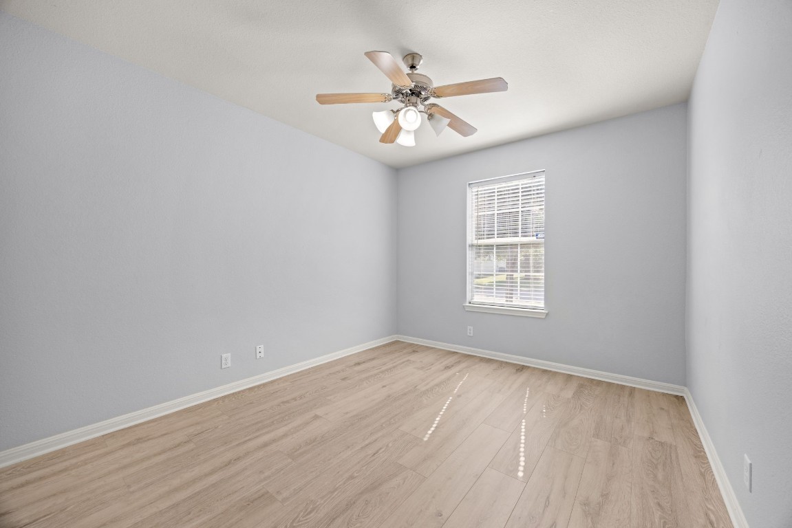 1323 Anna Palm Way Round Rock, TX 78665 - Photo 21 of 29 a view of an empty room with wooden floor and a window