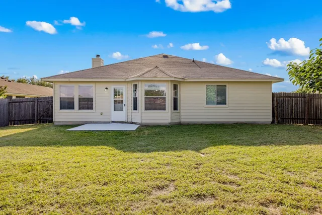 a view of a house with a backyard