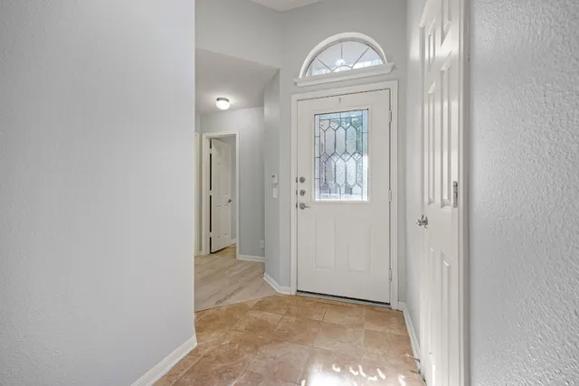a view of an entryway with wooden floor