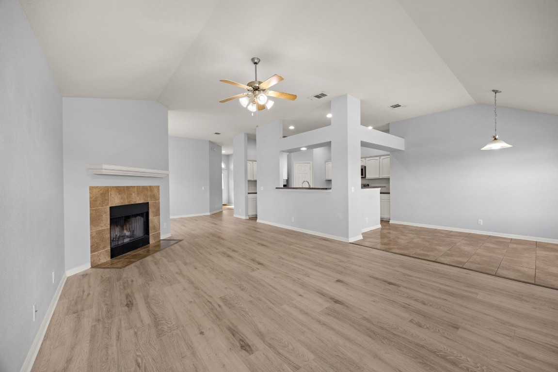 1323 Anna Palm Way Round Rock, TX 78665 - Photo 7 of 29 a view of an empty room with a fireplace and a fan