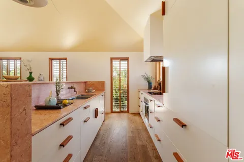 a large white kitchen with sink