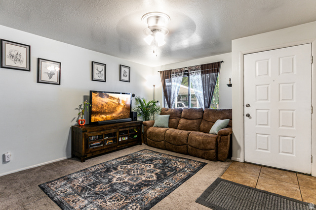 947 Canyon Road, Unit 33 Ogden, UT 84404 - Photo 8 of 19 Living area featuring light-colored walls and carpeted flooring