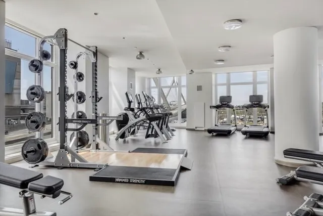 a room with gym equipment and a large window