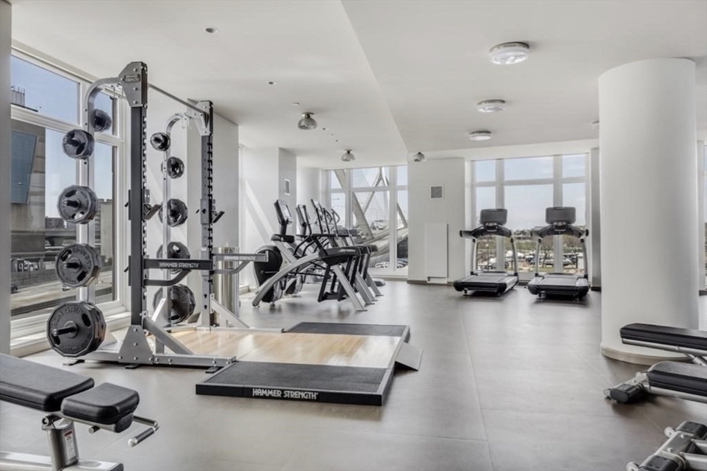 100 Lovejoy Wharf, Unit 8C Boston, MA 02114 - Photo 6 of 9 a room with gym equipment and a large window