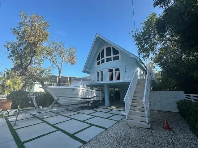 a front view of a house with fountain