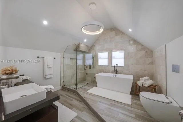 a spacious bathroom with a double vanity sink a mirror and a shower