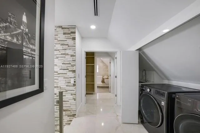 a view of a hallway with washer and dryer