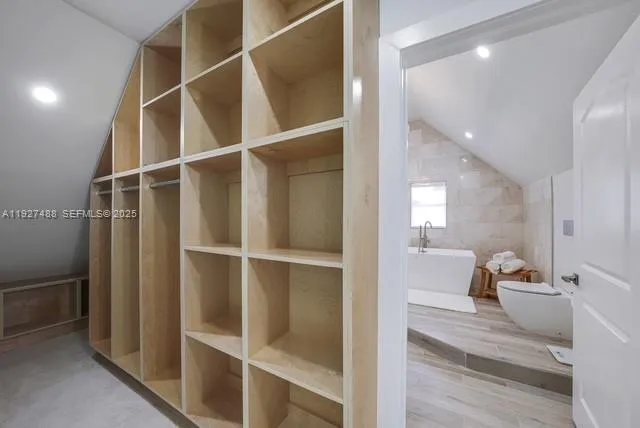 a view of a hallway with a furniture and a window