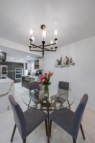 a room with furniture and view of kitchen