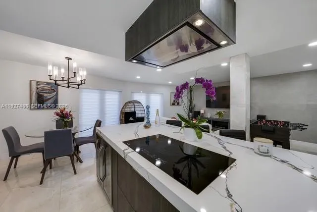 a kitchen with a sink a counter and chairs