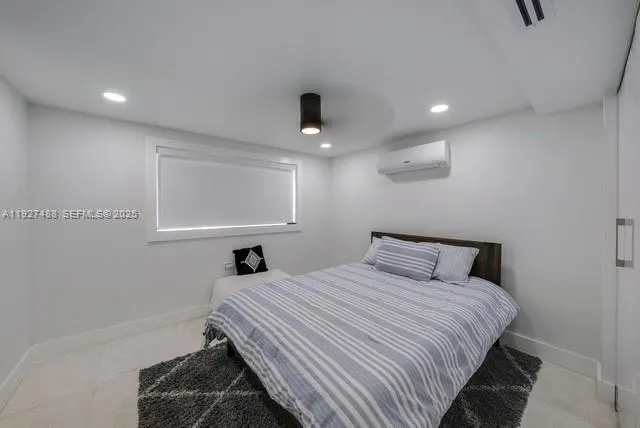 a bedroom with a bed and a lamp