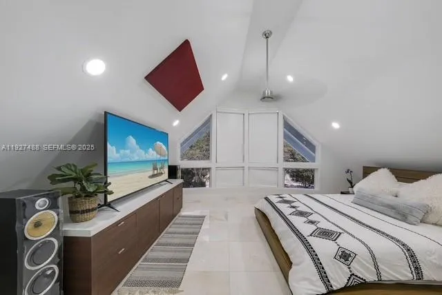 a large room with a bed and a flat screen tv