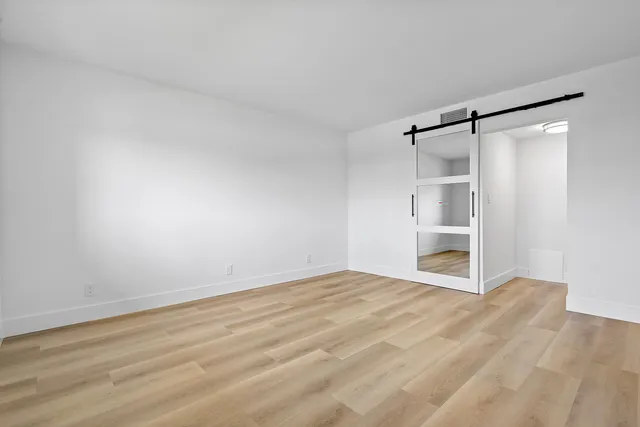a bedroom with a bed and a potted plant