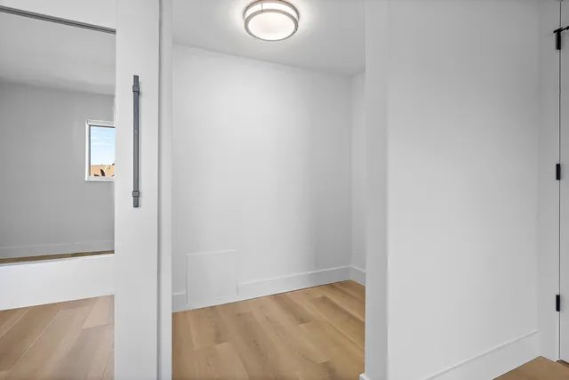 a bathroom with a toilet sink vanity tub and mirror