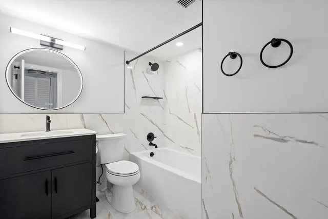 a view of a chair and tables in the balcony