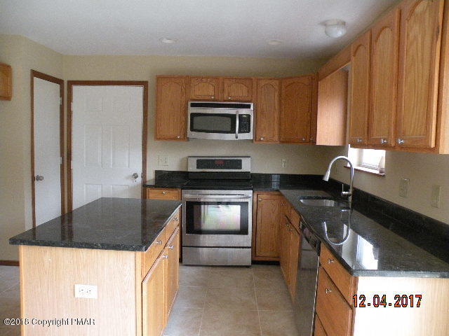 1604 Clover Road Long Pond, PA 18334 - Photo 2 of 18 a kitchen with stainless steel appliances granite countertop a sink stove and refrigerator