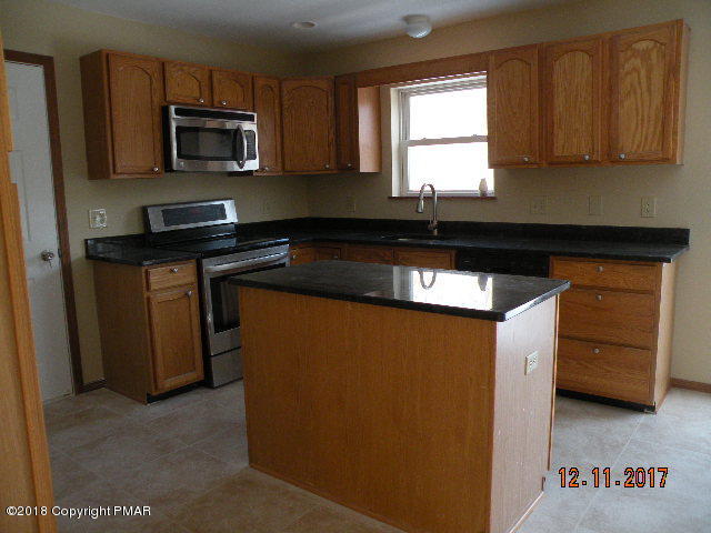 1604 Clover Road Long Pond, PA 18334 - Photo 6 of 18 a kitchen with granite countertop cabinets stainless steel appliances and a window