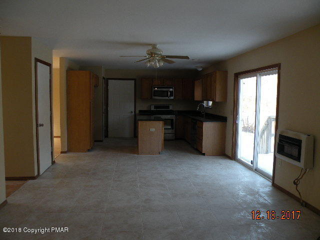 1604 Clover Road Long Pond, PA 18334 - Photo 9 of 18 a living room with stainless steel appliances granite countertop furniture a fireplace and a window