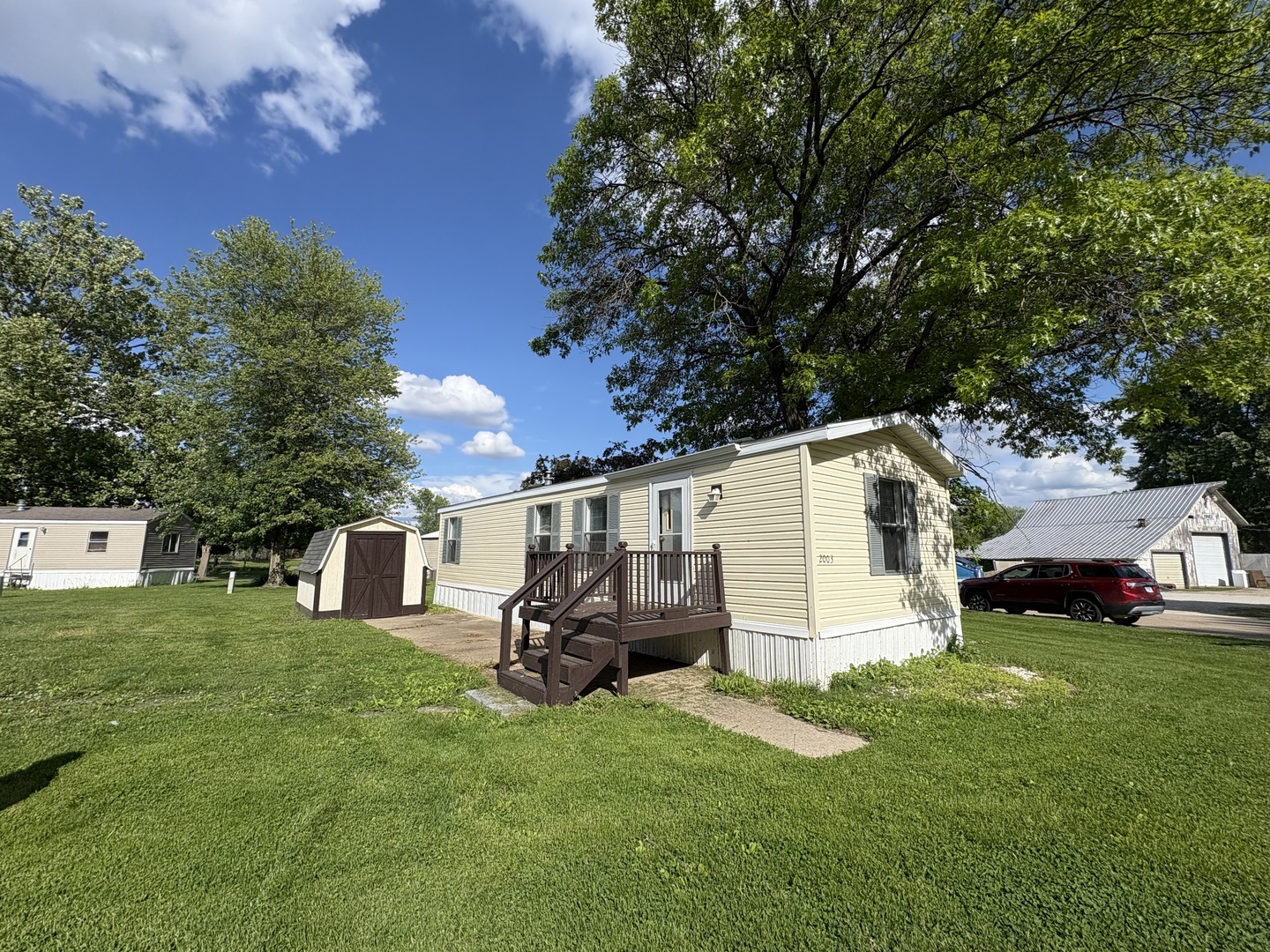 a view of a white house with a big yard