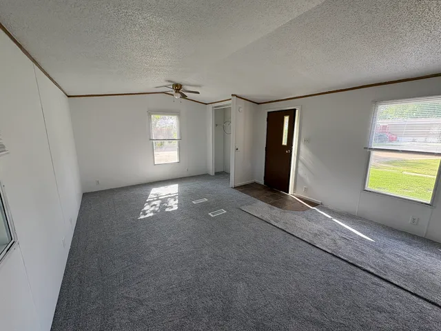 an empty room with windows and closet