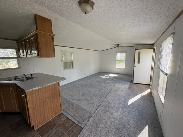 a view of a kitchen with a sink cabinets and a window