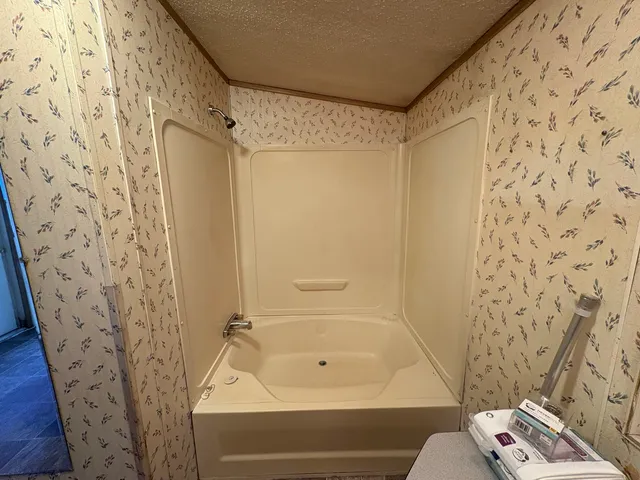 a bathroom with a bathtub and shower