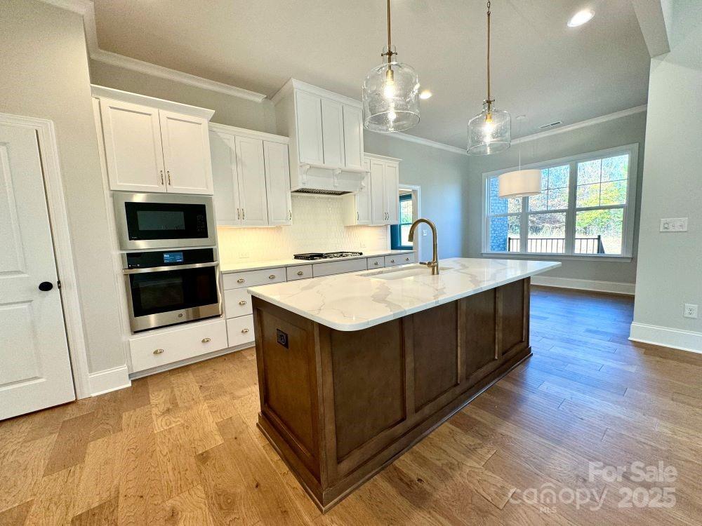 3850 Willow Grove Lane, Unit 24 Concord, NC 28025 - Photo 13 of 40 a kitchen with stainless steel appliances granite countertop a sink stove and a wooden floors